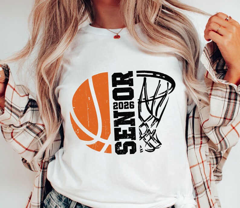 May include: White t-shirt with a black and orange basketball graphic and the text "Senior 2026".