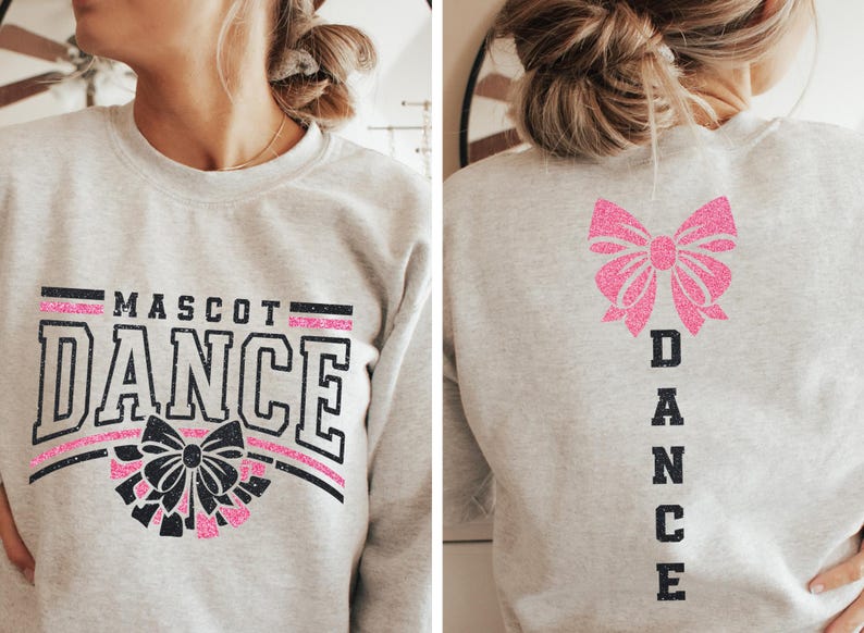 May include: A gray sweatshirt with the text "MASCOT DANCE" in black with a pink and black bow graphic on the front. The back of the sweatshirt has a pink bow graphic and the word "DANCE" vertically down the back.