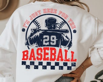 Może przedstawiać: Biała bluza z vintage'owym nadrukiem baseballowym i tekstem "I'm just here for the baseball". Nadruk przedstawia baseballistę w koszulce z numerem 29.