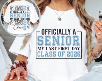 May include: White t-shirt featuring the text "OFFICIALLY A SENIOR MY LAST FIRST DAY CLASS OF 2026" in black and light blue. The shirt also has the text "SENIOR OFFICIALLY A SENIOR MY LAST FIRST DAY SENIOR Class of" in a smaller image.