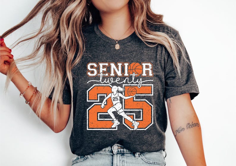 May include: A gray t-shirt with the text "Senior twenty" and a basketball player graphic. The number 25 is in orange with white outlines.