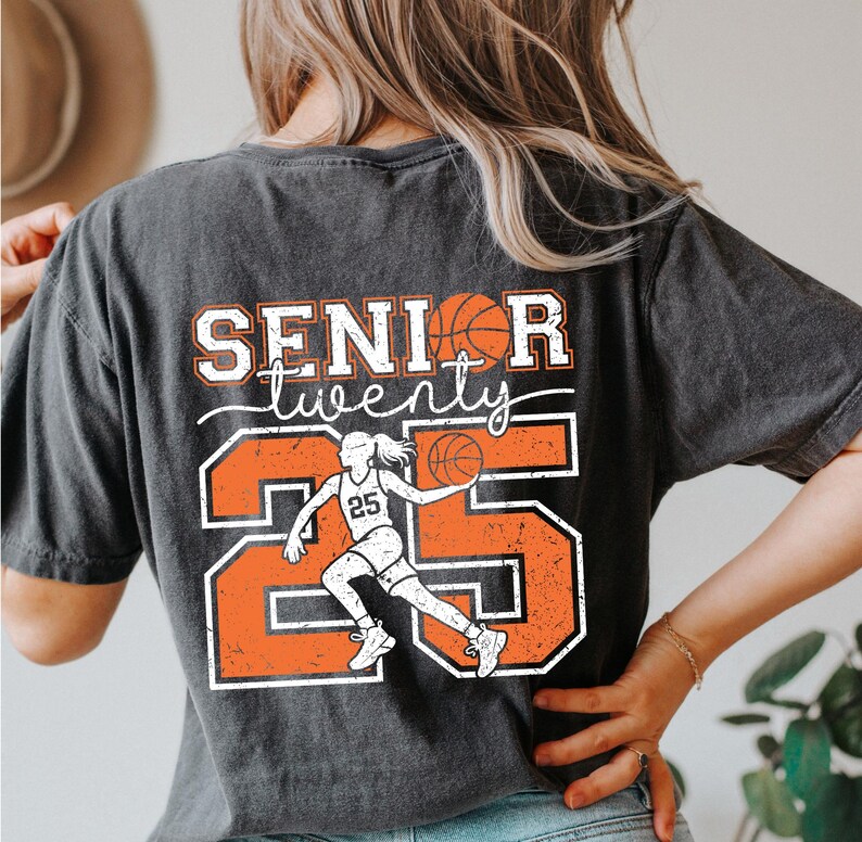 May include: Black t-shirt with a distressed orange and white graphic design. The graphic features a basketball player with the number 25 and the text "Senior twenty".
