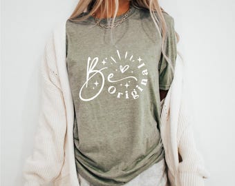 Puede incluir: Una camiseta verde con el texto "Be original" en letras blancas. El texto está rodeado de pequeñas estrellas y un corazón.