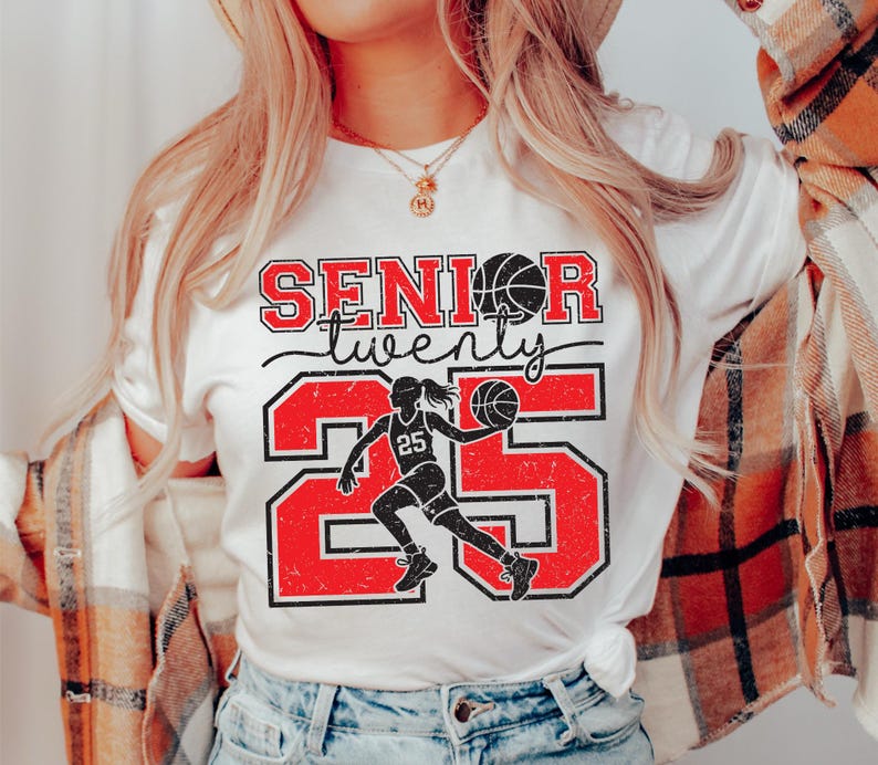 May include: White t-shirt with red and black text that says "Senior twenty five" with a basketball player graphic.