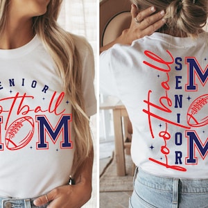 May include: White t-shirt with the words "SENIOR Football MOM" in red and blue. The design includes a football graphic. The back of the shirt also features the words "SENIOR Football MOM" in a similar design.