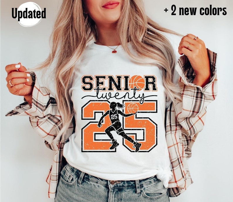 May include: White t-shirt with an orange and black graphic design that says "Senior twenty" with a basketball player silhouette and the number 25.