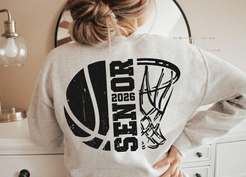 May include: A gray sweatshirt with a black basketball and basketball hoop graphic. The graphic includes the word "Senior" and the year "2026".