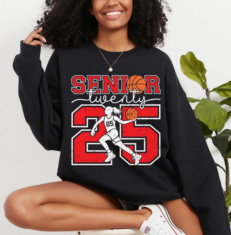 May include: Black sweatshirt with a red and white graphic design featuring a basketball player and the text "Senior twenty 25".