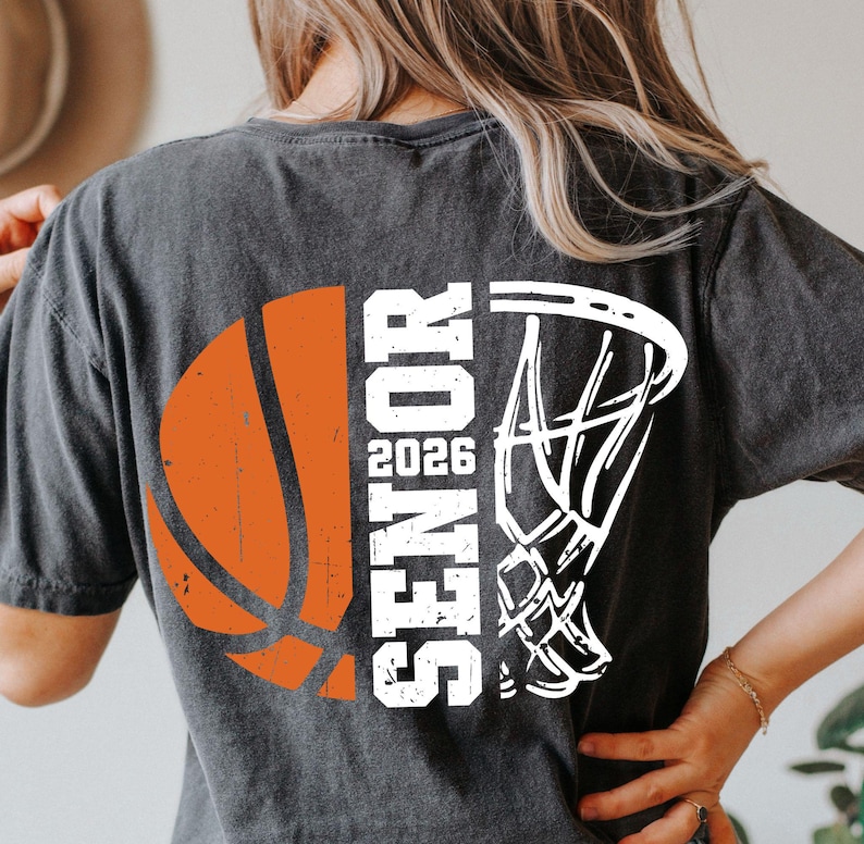 May include: A black t-shirt with a white basketball and hoop graphic. The text "Senior 2026" is printed vertically on the shirt.
