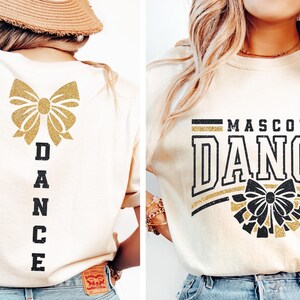 May include: A white t-shirt with a gold glitter bow and the word "DANCE" in black vertical lettering on the back. The front of the shirt has a black and gold glitter design with the words "MASCOT DANCE" in black lettering.