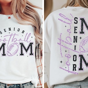 May include: White t-shirt and sweatshirt with the text "Senior Football Mom" in black and purple glitter. The design includes a football graphic. The sweatshirt has the same design on the back.