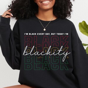May include: Black sweatshirt with the text "I'm Black every day, but today I'm Blackity Black Black" in a rainbow color scheme.