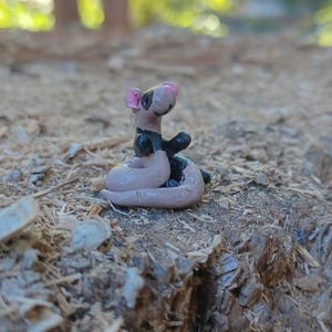 Brown and black ferret figurine.