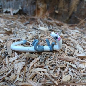 White and Grey ferret figurine.