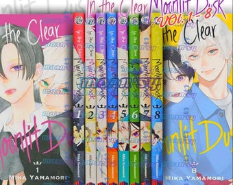 Puede incluir: Una colección de ocho volúmenes de manga titulada "In the Clear Moonlit Dusk" de Mika Yamamori. Las portadas presentan ilustraciones coloridas de personajes de estilo anime con cabello y ojos vibrantes. Las lomos muestran los números de volumen 1-8.