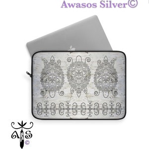 May include: A white laptop sleeve with a black and white design of three stylized turtles. The design features intricate details and a repeating border pattern.