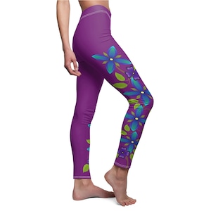 Op de afbeelding: Paarse leggings met een bloemenpatroon met blauwe en groene bloemen. De bloemen zijn verticaal op het rechterbeen gerangschikt.