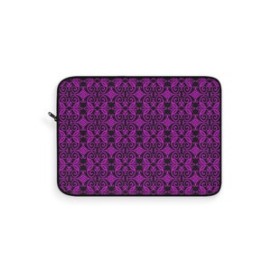May include: A black laptop sleeve with a repeating pattern of pink, intricate swirls and designs.