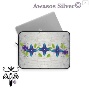 May include: A laptop sleeve with a white birch bark background and a blue and purple floral design. The design features a row of blue flowers with green leaves and purple accents.