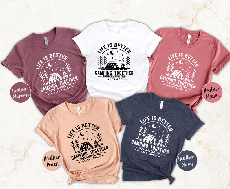 May include: A collection of five short-sleeved t-shirts in various colors, each featuring a camping-themed graphic. The design includes the text "LIFE IS BETTER CAMPING TOGETHER 2025 CAMPING TRIP LAKE TAHOE."