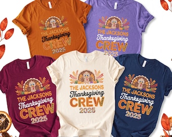 May include: Five colorful t-shirts with a Thanksgiving theme. Each shirt features a turkey graphic and the text "THE JACKSONS Thanksgiving CREW 2025" in various colors, including orange, purple, burgundy, cream, and navy blue.