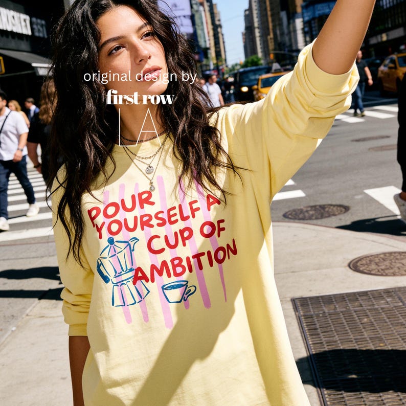 Woman wearing Dolly Parton Pour Yourself a Cup of Ambition Shirt, Retro Coffee T, 9 to 5 Country Music Tee, Moka Pot, Coffee Club, Long Sleeve T-Shirt.

Original design and copyright by first row LA 2025.