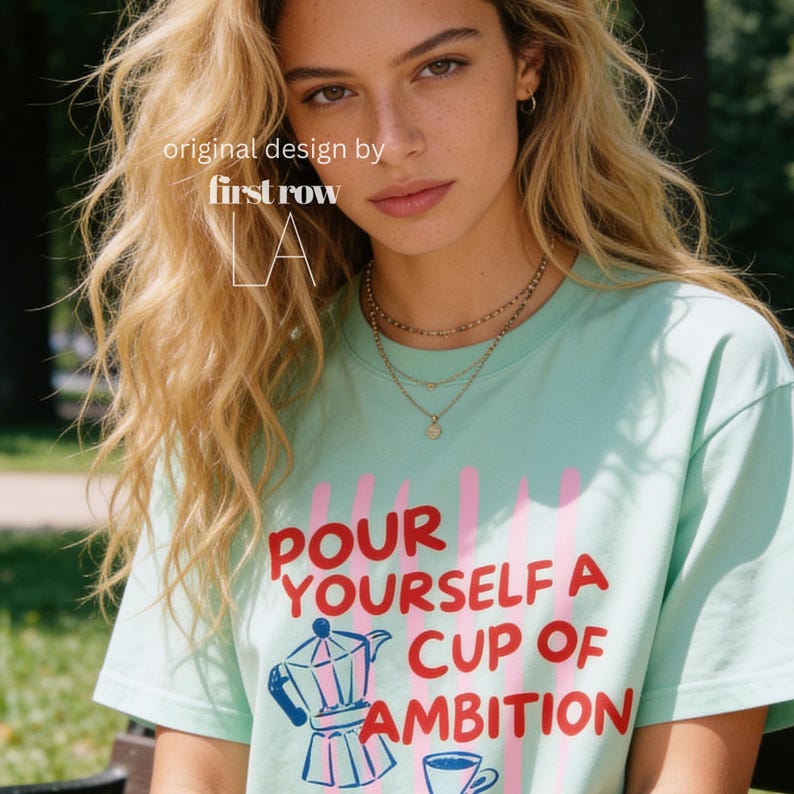 Woman wearing Dolly Parton "Pour Yourself a Cup of Ambition" Shirt, Retro Coffee Graphic, 9 to 5 Country Music Tee, Moka Pot, Coffee Club, Caffeine Lover.

Original desgin and copyright by first row LA.