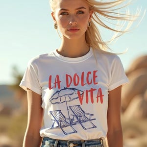 Model wearing a white tee with the text LA DOLCE VITA across the chest.
Two sun chairs. One umbrella. Zero worries. Italy -where the espresso hits hard, the gelato never melts, and responsibility? Never heard of her.
Endless summer, featuring a dreamy graphic of striped beach bliss. Perfect for sun-chasers, rule-breakers, and anyone who believes naps are a lifestyle.
La Dolce Vita shirt, Tomato Girl summer, Limoncello, spaghetti vibes. Retro foodie, Portofino, Amalfi Coast Shirt, Sardines Tee