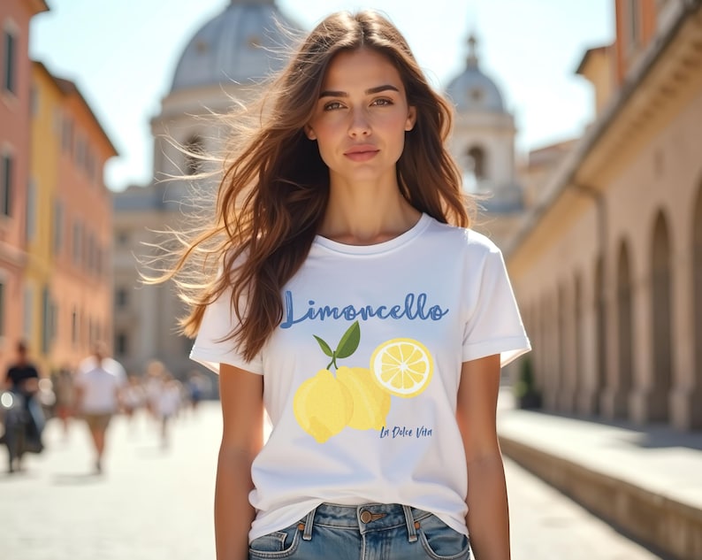Model wearing white T-shirt with the text Limoncello, La Dolce Vita, follewed by a juicy lemon graphics.
Limoncello Shirt, La Dolce Vita Tee, Lemon Shirt, Amalfi Coast, Italy TShirt, Vacay T-Shirt, Lemons Tee, Cocktail T Shirt, Retro Graphic Tee