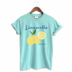 Chalky Mint T-shirt with the text Limoncello, La Dolce Vita, follewed by a juicy lemon graphics.
Limoncello Shirt, La Dolce Vita Tee, Lemon Shirt, Amalfi Coast, Italy TShirt, Vacay T-Shirt, Lemons Tee, Cocktail T Shirt, Retro Graphic Tee