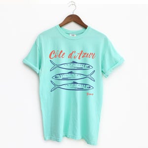 Island Reef T-shirt with the text Côtes d'Azur, France.

Côtes d'Azur France T-Shirt, Old Money Aesthetic, 3 Fish , French Riviera, Heritage, Sardines TShirt, France Travel Tee, Coastal Aesthetic, Retro Graphic Tee, French Vacation, Mediterranean