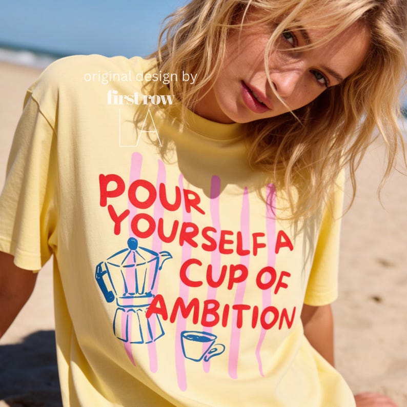 Woman wearing Dolly Parton "Pour Yourself a Cup of Ambition" Shirt, Retro Coffee Graphic, 9 to 5 Country Music Tee, Moka Pot, Coffee Club, Caffeine Lover.

Original desgin and copyright by first row LA.