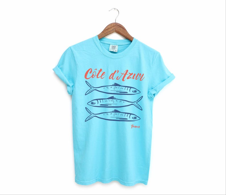 Lagoon Blue T-shirt with the text Côtes d'Azur, France.

Côtes d'Azur France T-Shirt, Old Money Aesthetic, 3 Fish , French Riviera, Heritage, Sardines TShirt, France Travel Tee, Coastal Aesthetic, Retro Graphic Tee, French Vacation, Mediterranean