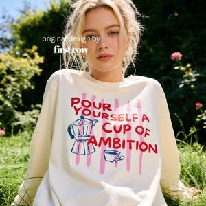 Woman wearing Dolly Parton Pour Yourself a Cup of Ambition Shirt, Retro Coffee T, 9 to 5 Country Music Tee, Moka Pot, Coffee Club, Long Sleeve T-Shirt.

Original design and copyright by first row LA 2025.