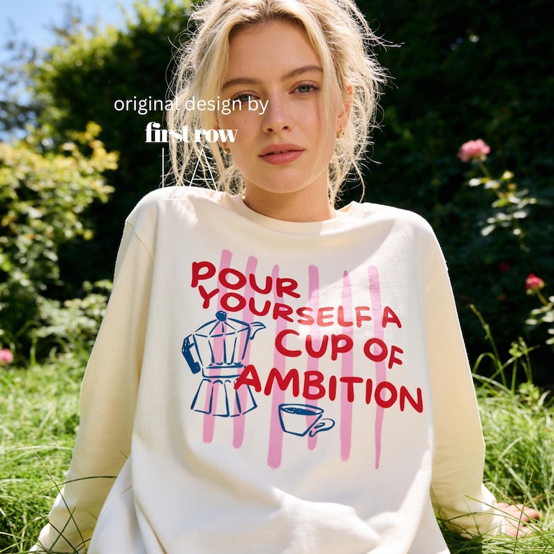 Woman wearing Dolly Parton Pour Yourself a Cup of Ambition Shirt, Retro Coffee T, 9 to 5 Country Music Tee, Moka Pot, Coffee Club, Long Sleeve T-Shirt.

Original design and copyright by first row LA 2025.