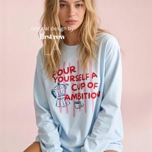 Woman wearing Dolly Parton Pour Yourself a Cup of Ambition Shirt, Retro Coffee T, 9 to 5 Country Music Tee, Moka Pot, Coffee Club, Long Sleeve T-Shirt.

Original design and copyright by first row LA 2025.