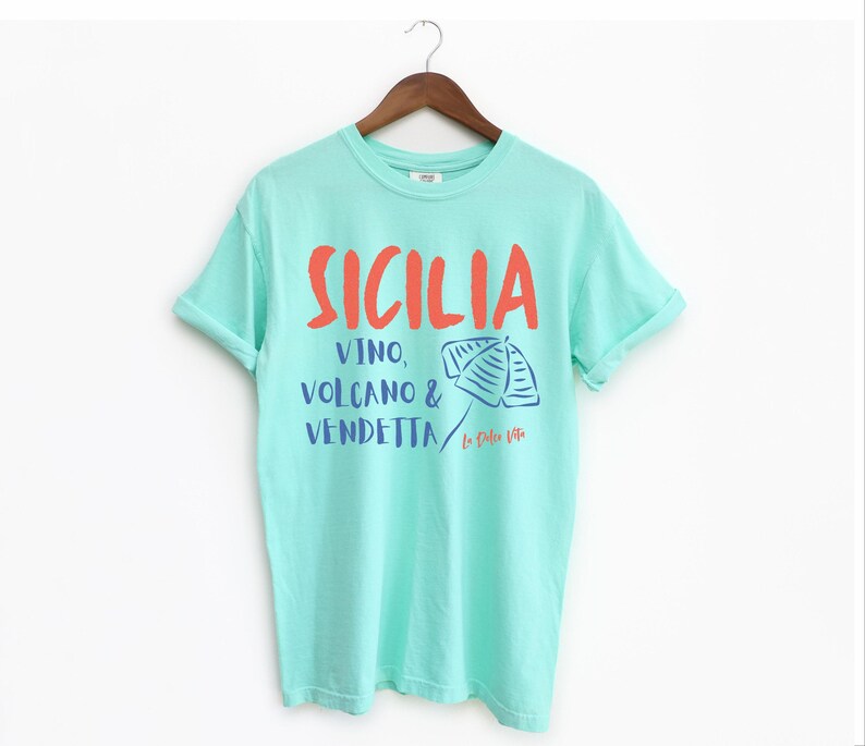 Island Reef T-shirt with the text Sicilia, Vino, Volcano and Vendetta, La Dolce Vita. 

A wearable love letter to the drama, beauty, and indulgence of Sicilian culture.

Great for wine lovers, pasta enthusiasts, spontaneous adventurers, and anyone who knows that revenge is a dish best served... with a glass of Nero d’Avola.
Wear it to your next pizza night, wine tasting, or while planning your escape to the Amalfi Coast.
