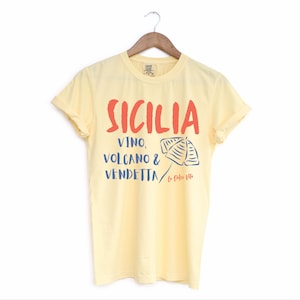Butter Yellow T-shirt with the text Sicilia, Vino, Volcano and Vendetta, La Dolce Vita. 

A wearable love letter to the drama, beauty, and indulgence of Sicilian culture.

Great for wine lovers, pasta enthusiasts, spontaneous adventurers, and anyone who knows that revenge is a dish best served... with a glass of Nero d’Avola.
Wear it to your next pizza night, wine tasting, or while planning your escape to the Amalfi Coast.