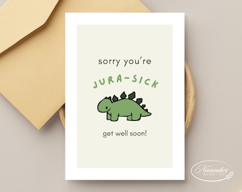 Może przedstawiać: Biała kartka z zielonym tłem, na której znajduje się zielony dinozaur z białym obramowaniem i tekstem "sorry you're JURA-SICK get well soon!"