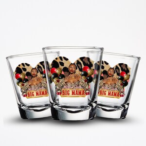 May include: Three clear shot glasses with a decorative design. Each glass features a woman in a leopard print top, surrounded by balloons and the text "BIG MAMA". The background includes a leopard print heart.