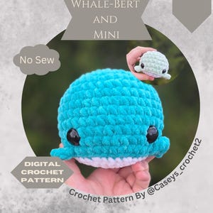 May include: A crocheted blue whale with black eyes and white accents. The image includes a smaller, similar whale. Text on the image reads "WHALE-BERT AND MINI", "No Sew", "Ocean Animals", and "DIGITAL CROCHET PATTERN".