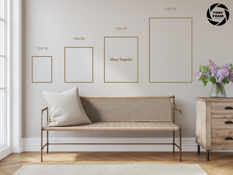 a living room with a beige sofa and a wooden dresser. Above the sofa, there are four framed pictures of different sizes, indicating the dimensions of the pictures. The largest picture is 24x36, followed by 18x24, 16x20, and 12x16. The smallest picture is 12x16. The sofa has a white pillow on it. The dresser has a vase of flowers on top.