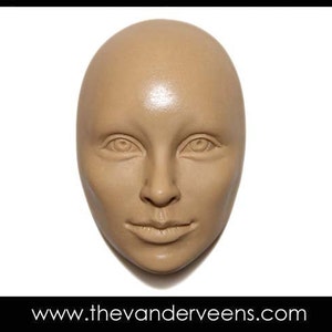 May include: A beige plaster cast of a human face. The face is neutral with closed lips and a smooth surface.