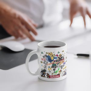 May include: White ceramic mug with a wrap-around design featuring cartoon illustrations of a doge, rocket, and other crypto-related graphics. The mug has the word "Satoshi" at the bottom and other text like "FOMO" and "Buy the Dip".