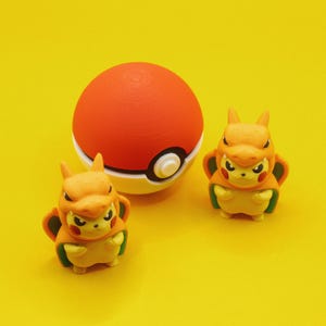 Könnte beinhalten: Zwei orangefarbene und gelbe Comicfiguren mit roten Augen und einem roten und weißen Pokéball.