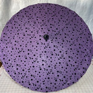 Purple moon and stars on a black parasol
