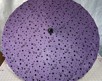 Purple moon and stars on a black parasol