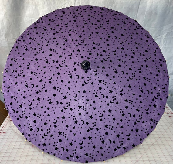 Purple moon and stars on a black parasol
