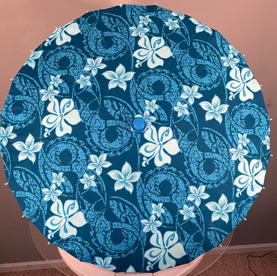 Blue Polynesian parasol with white flowers