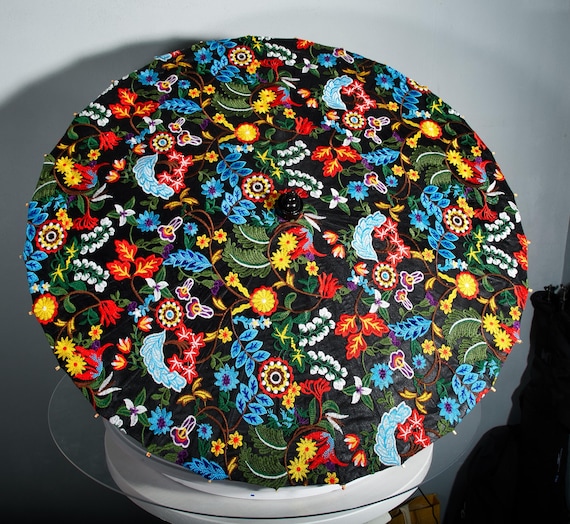 Embroidered colorful flowers on a black parasol